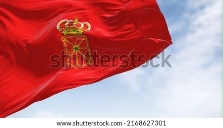 The Navarre flag waving in the wind on a clear day. Navarre is an autonomous community and province in northern Spain