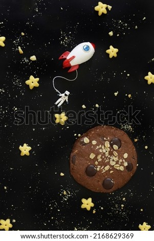 Miniature Astronaut and rocket travel in universe cookies plant.