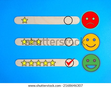 Customer service evaluation and satisfaction survey concepts. Images of emoticons and rating satisfaction at ice cream stick Royalty-Free Stock Photo #2168646307
