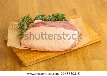 Raw duck breast for cooking over board