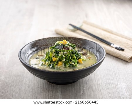 Poached Chinese Spinach with Egg Trio and Minced Pork with chopsticks served in a dish isolated on mat side view on grey background
