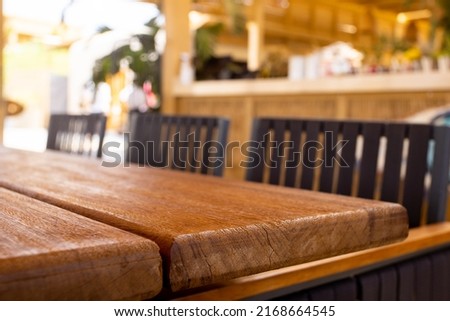 Table empty background in cafe ,restaurant background.Front view. . Dining table. Brochure background.Bar outside in summer vacation 