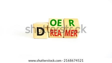 Doer or dreamer symbol. Concept words Doer or dreamer on wooden cubes. Beautiful white table white background. Business and doer or dreamer concept. Copy space. Royalty-Free Stock Photo #2168674521