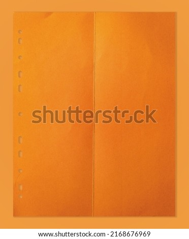 folded orange divider sheet isolated on orange paper background. cool paper overlay or poster element.