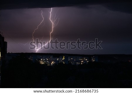 Lightning on the background of the night city. Rain