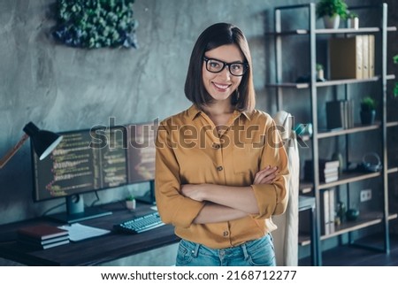 Portrait of attractive cheerful skilled experienced girl database editor folded arms at workplace workstation indoors