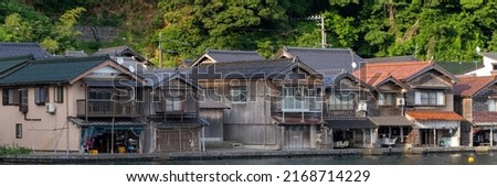 Lined up boathouses at Ine Town in Kyoto, Japan Royalty-Free Stock Photo #2168714229