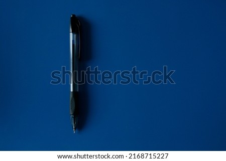 black ballpoint on flat blue surfaces top view