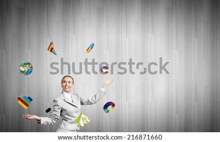 Young pretty businesswoman juggling with white balls. Elements of this image are furnished by NASA