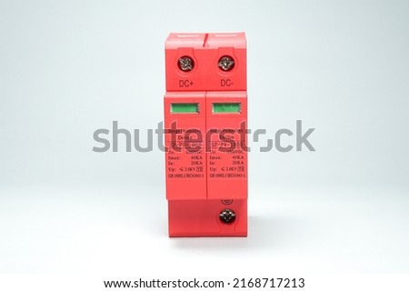 Surge Protective Device (SPD) is a tool to protect electrical installations from lightning strikes. Red DC surge arrester breaker on white background isolated. Royalty-Free Stock Photo #2168717213
