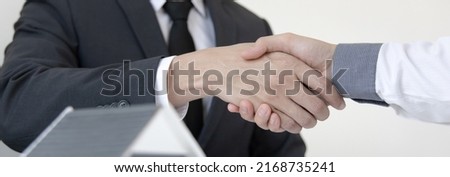 Real estate agents and customers shake hands to congratulate on signing a contract to buy a house with land and insurance, handshake and Good response concept.