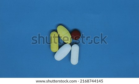 
medicinal pills to cure disease to be healthy with a blue isolated background used by doctors for various diseases