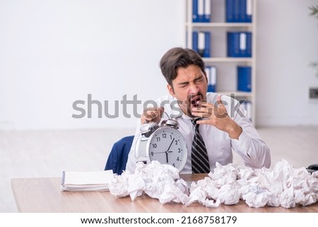 Young male employee in brainstorming concept
