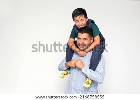 Single dark-haired dad Latino and hispanic son play and have fun together spending quality family time on Father's Day celebrating victory with hugs and kisses
 Royalty-Free Stock Photo #2168758555