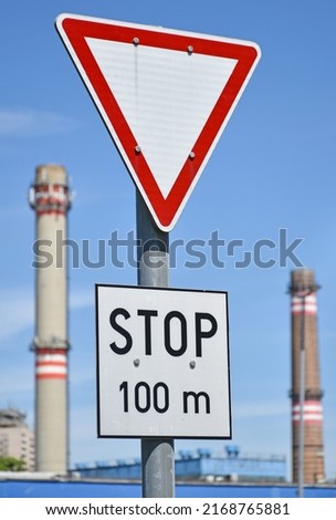 Yield traffic sign and smoke stacks