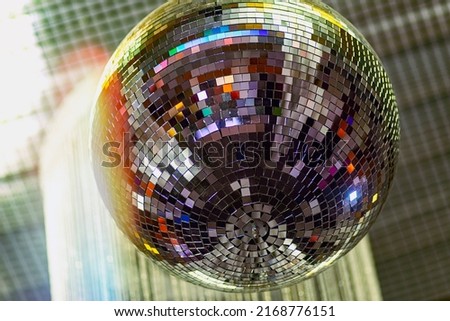 Disco ball with bright beams, night party background photo