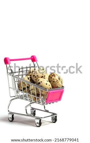 Small quail eggs in a shopping trolley on a white background, healthy food