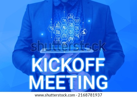 Handwriting text Kickoff Meeting. Business approach Special discussion on the legalities involved in the project Man holding Screen Of Mobile Phone Showing The Futuristic Technology. Royalty-Free Stock Photo #2168781937