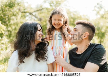 Family resting in nature sitting on the grass