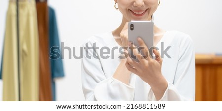 Woman using a smartphone in an apparel store