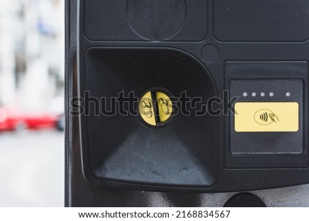 Parking meter slot for coins also contactless payment as alternative