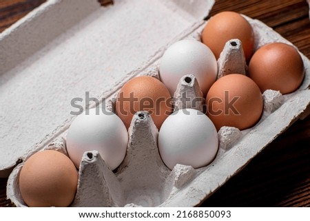Chicken eggs in a tray - brown and white.
