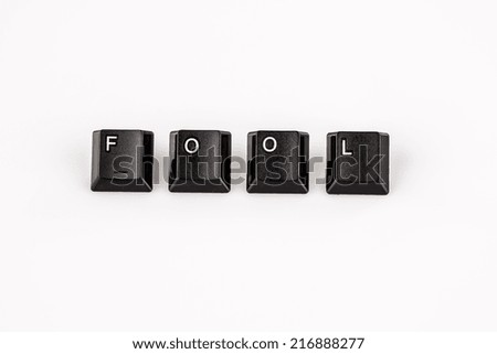 fool word written with black computer buttons on white background