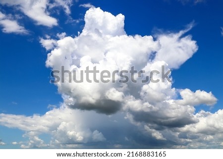 White cumulonimbus clouds against the blue sky, summer