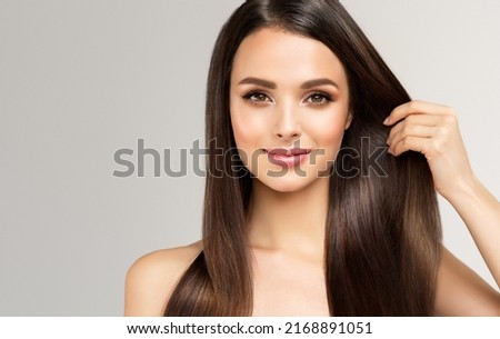 Beautiful model girl with shiny brown and straight long  hair . Keratin  straightening . Treatment, care and spa procedures. Smooth hairstyle
 Royalty-Free Stock Photo #2168891051