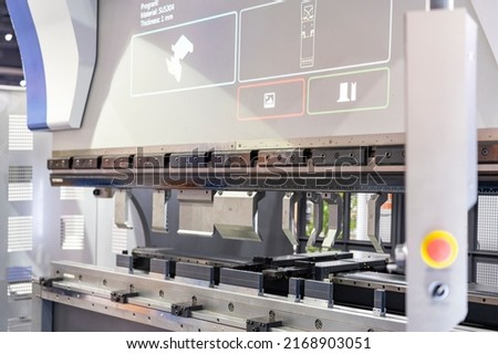 Close up punch and v die of the semi automatic cnc hydraulic press brake or bending machine  during folding forming. Royalty-Free Stock Photo #2168903051