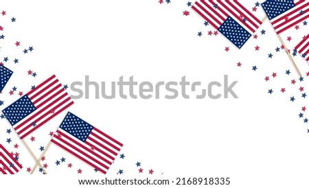USA Independence Day July 4th. Mini USA flags and confetti stars on a wooden background with copy space.