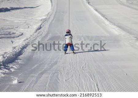 girl in ski lift of an italian ski resort in the dolomites