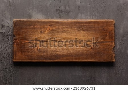 Wooden nameplate or sign board screwed on wall background. Front view of name plate Royalty-Free Stock Photo #2168926731