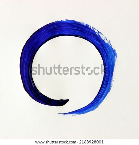 Blue circle ornamental frame painted with acrylic color and brush.