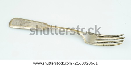 Beautiful antique fork on a white background. Retro articles.