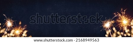 Silvester, New Year's Eve 2023 Party, New year, Fireworks, Firework holiday celebration background banner panorama long greeting card - Sparklers and bokeh lights on dark blue night sky Royalty-Free Stock Photo #2168949563