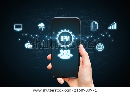 Concept BPM or Business process management. Holographic icons by the phone in the hands of a person. Royalty-Free Stock Photo #2168980971
