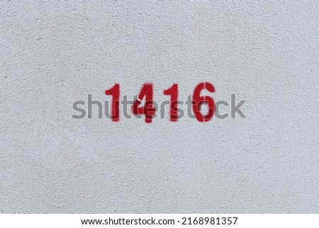 Red Number 1416 on the white wall. Spray paint.
