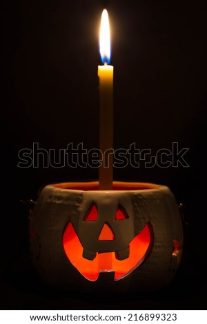Jack O Lantern halloween and a candle isolated on dark background