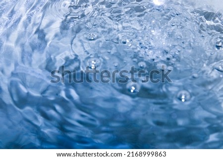 The water is turquoise with many small and large spheres floating bubbles that give a feeling of freshness and coolness.