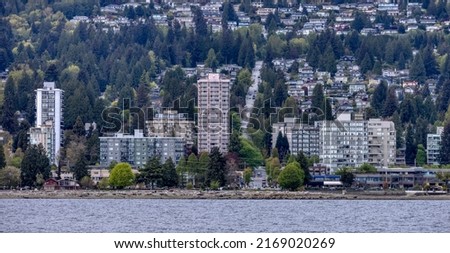 Residential Buildings in a modern city on the West Coast of Pacific Ocean. West Vancouver, British Columbia, Canada. Royalty-Free Stock Photo #2169020269