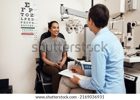 Is this the first eye test youve had. Shot of a young woman having an eye exam by an optometrist. Royalty-Free Stock Photo #2169036931