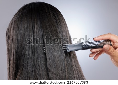 Thick, glossy strands go a long way toward making hair look healthy. Studio shot of a woman with healthy brown hair. Royalty-Free Stock Photo #2169037393