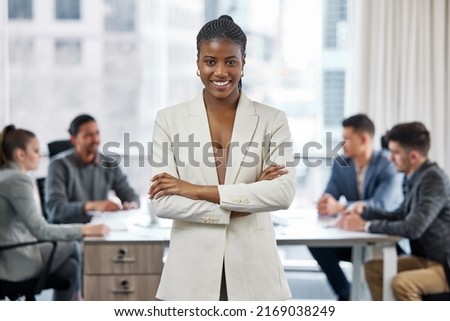 You can call me boss lady. Shot of a young businesswoman standing with her arms crossed in a meeting at work. Royalty-Free Stock Photo #2169038249