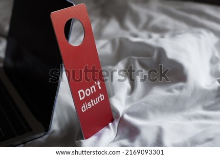 door hanger with "do not disturb" sign