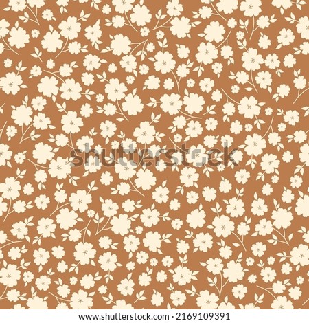 Simple vintage pattern. White flowers and leaves. Brown background. Fashionable print for textiles and wallpaper. Royalty-Free Stock Photo #2169109391