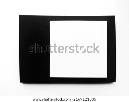 White square on black rectangular background. Isolated black frame with white square inside. White and black paper frame concept. Mock up