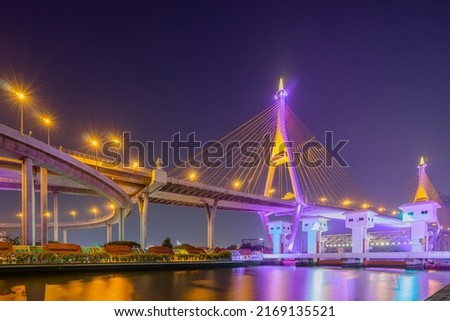 Night scenic of light up on the highway bridge across the Chao Phraya river with the Watergate in Samut Prakan, Thailand