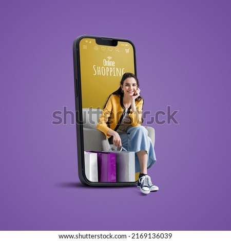 Happy young woman with shopping bags in a smartphone, online shopping and sales concept, blank copy space Royalty-Free Stock Photo #2169136039