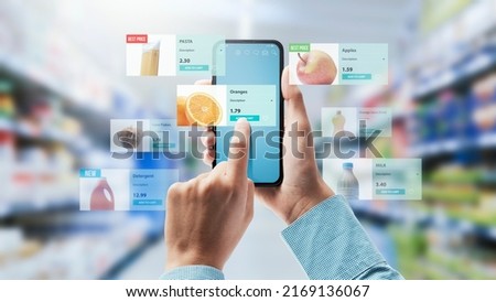 Augmented reality in retail: woman doing grocery shopping and checking products information using her smartphone Royalty-Free Stock Photo #2169136067